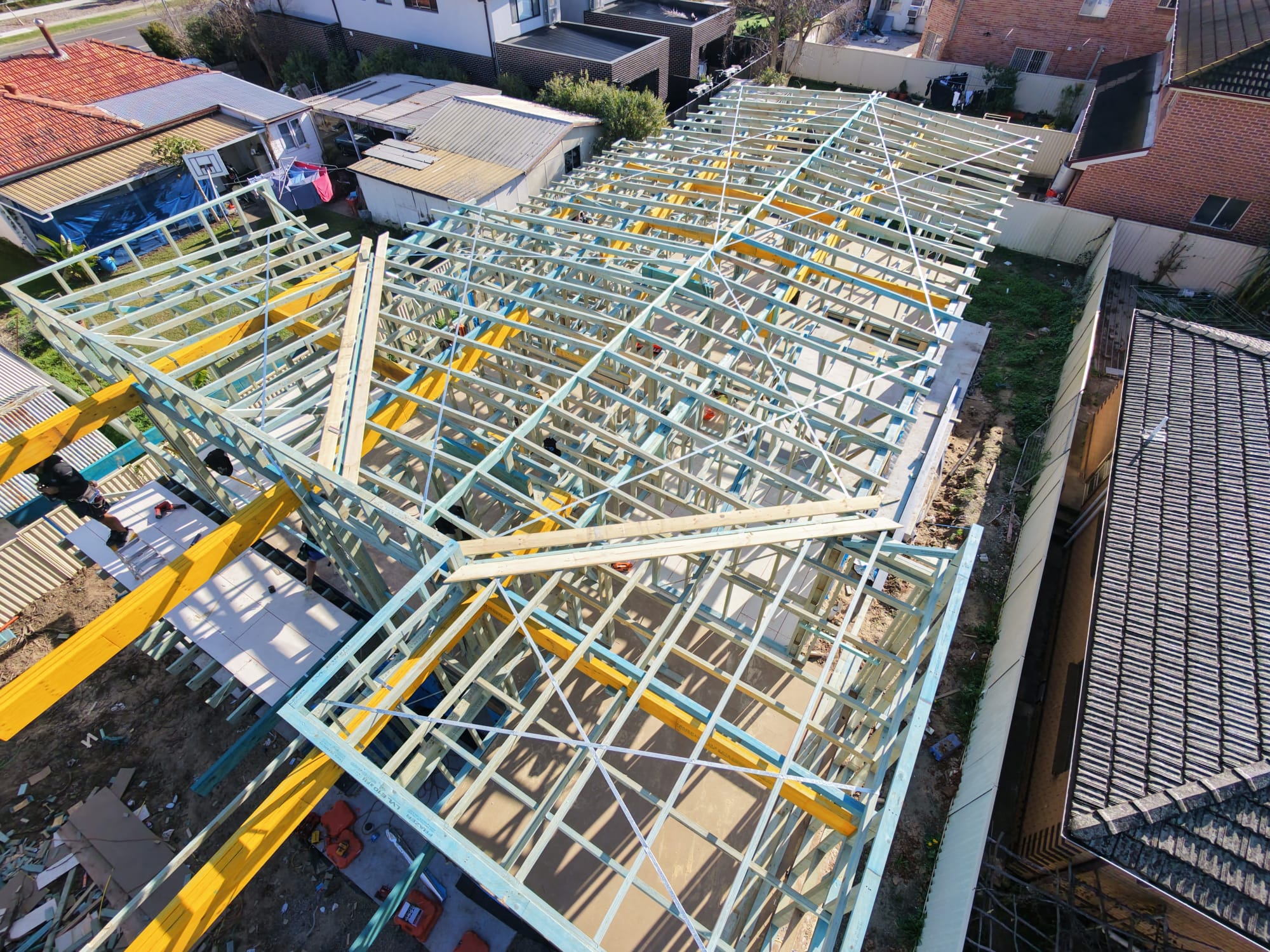 Roof frame under construction with engineered LVL beams and steel bracing